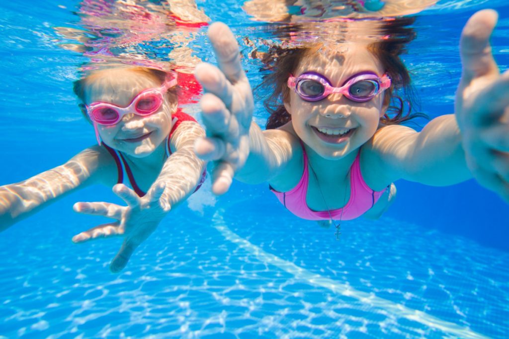 Two girls having fun swimming in the pool